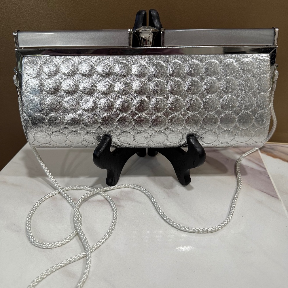 NWOT Kate Landry silver clutch with circles.  Large‎ "diamond" clasp,